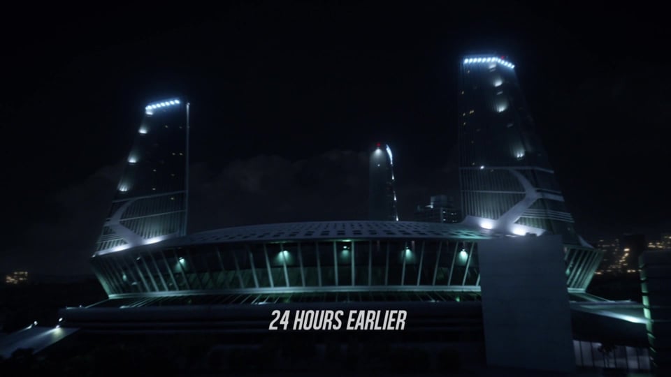 A view of Star Labs, an imposing industrial-looking building with a bit of a Sydney Opera house vibe, with a Chiron saying 24 Hours Earlier