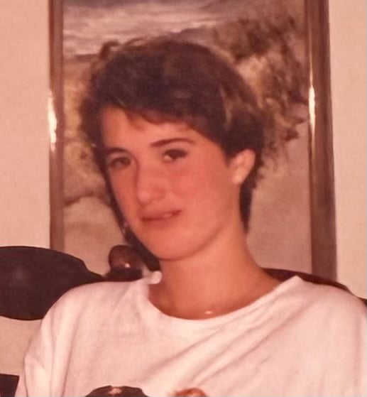 Awkward teenage me with short brown hair and an oversized white tee shirt.