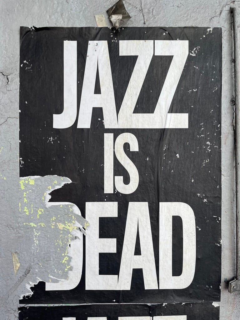 Torn poster of "Jazz is Dead"