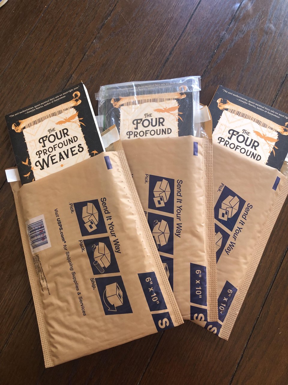 three copies of The Four Profound Weaves, each sticking out of a USPS mailer