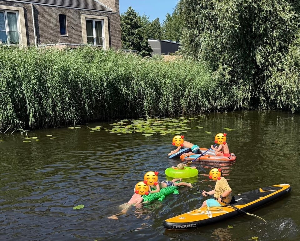 Children playing in a canal on a hot day.