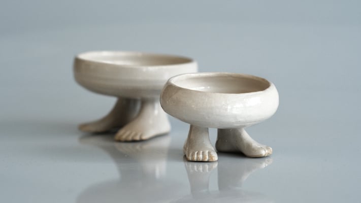 A photograph of a pair of footed bowls