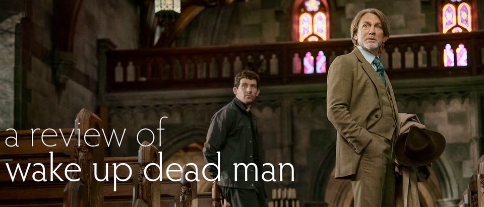 Header image reading of Benoit Blanc and Father Jud in a church with the words "A Review of Wake Up Dead Man"