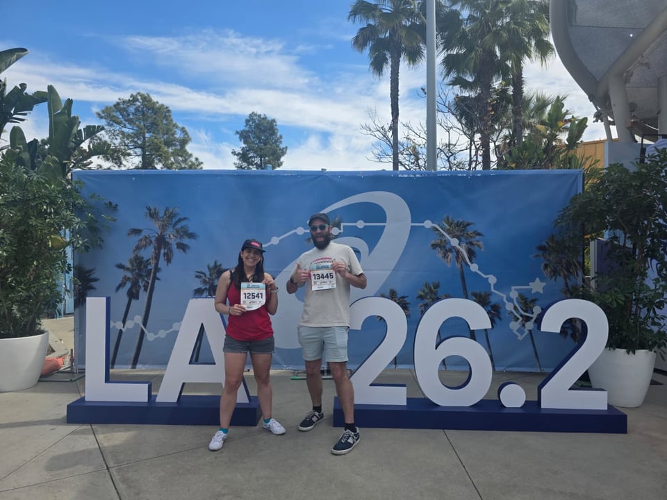 Me and Gini at the LA Marathon expo, in front of big LA 26.2 letters.