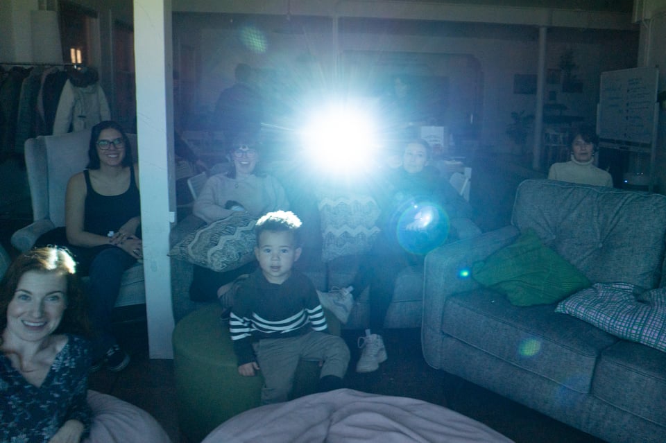 A group of people looking at a screen.