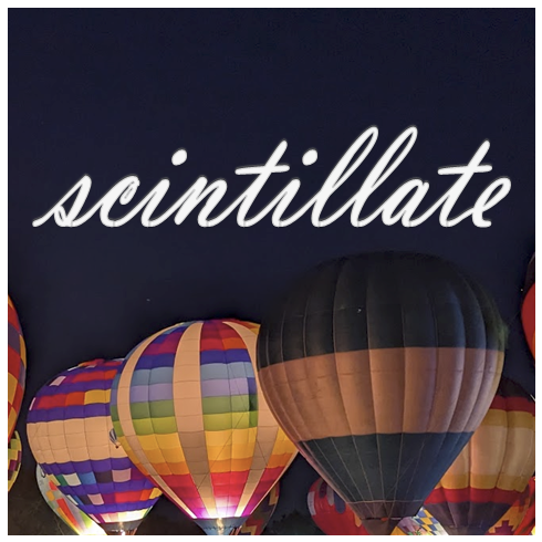 white text in cursive font that reads: scintillate. Various hot air balloons at night are glowing.