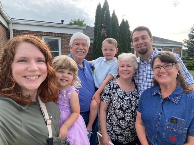 a family in front of a building
