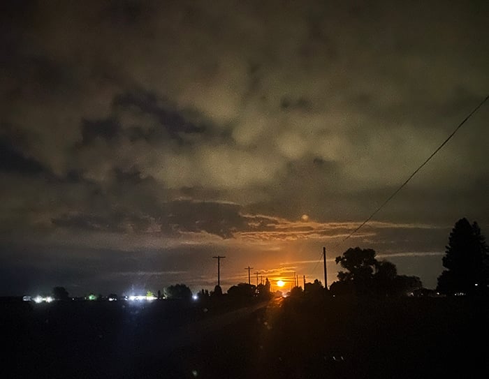 A grainy phone photo of a moonrise on the night of September 1, 2023