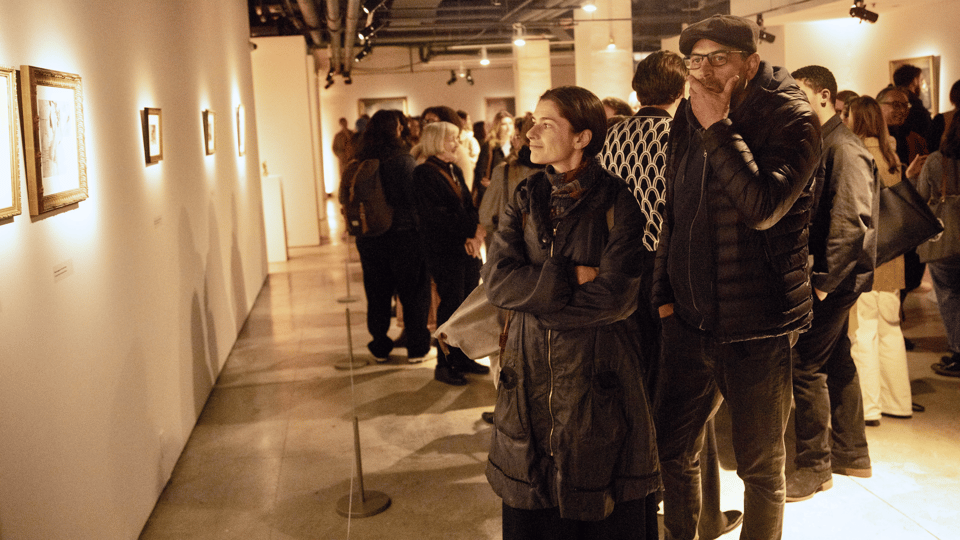 Patrons look at the art inside the gallery