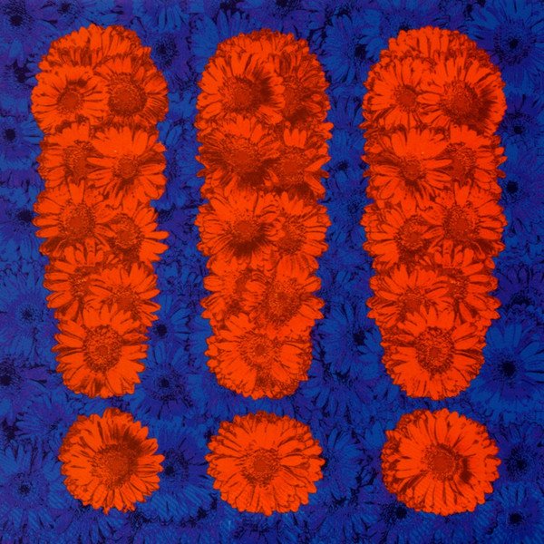 Three bright red exclamation marks, made out of sunflowers (?), on a dark blue background, also made of sunflowers.