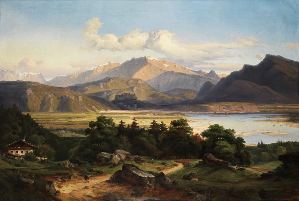a lake with mountains in the background
