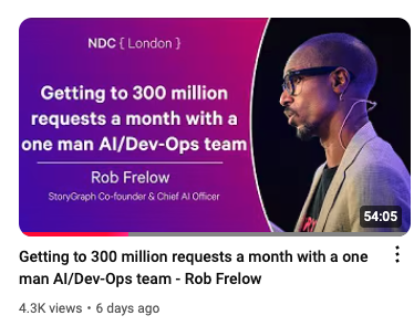 The image shows a YouTube video cover photo featuring Rob Frelow, Co-founder & Chief AI Officer at StoryGraph. He's depicted speaking at an event with the title "Getting to 300 million requests a month with a one man AI/Dev-Ops team" highlighted, indicating the subject matter of the video.