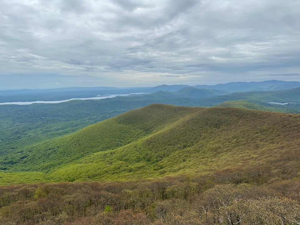 photo of the view from the Overlook Mountain fire tower, of trees and the Hudson River