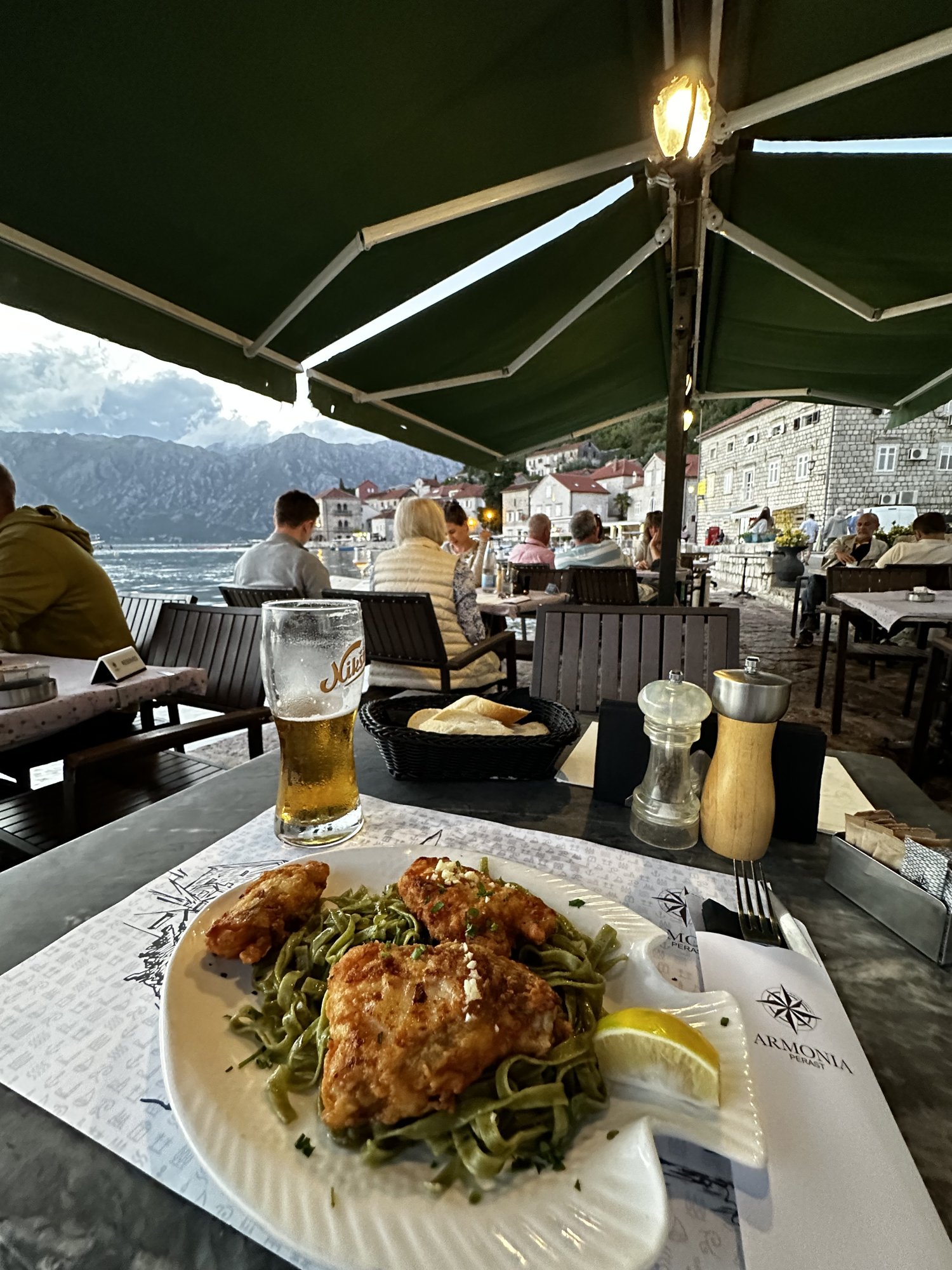 Dinner on a waterfront terrace in Perast, with the bay behind the table