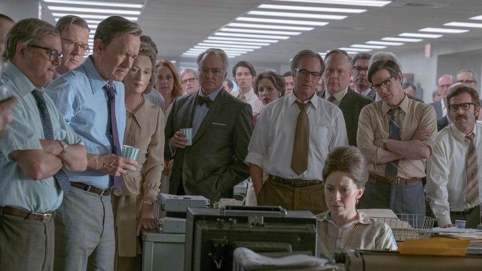 A scene from The Post (2017) where people at The Washington Post are waiting for the Supreme Court ruling.