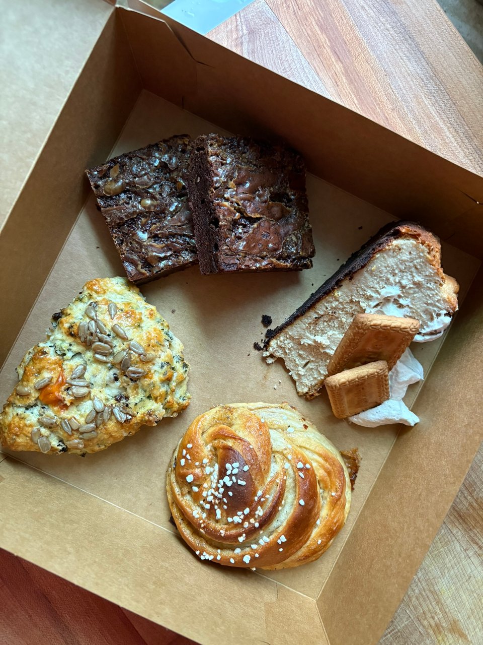 A box of treats with a cardamom roll featured in the bottom corner of the picture.