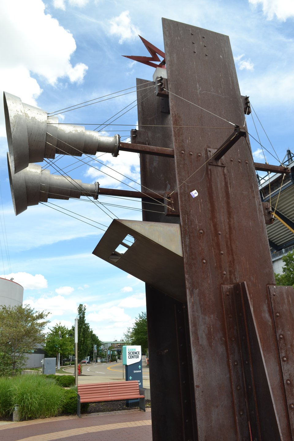 A sculpture that consists of an I-beam and what appear to be bizarre hornes wired to it.