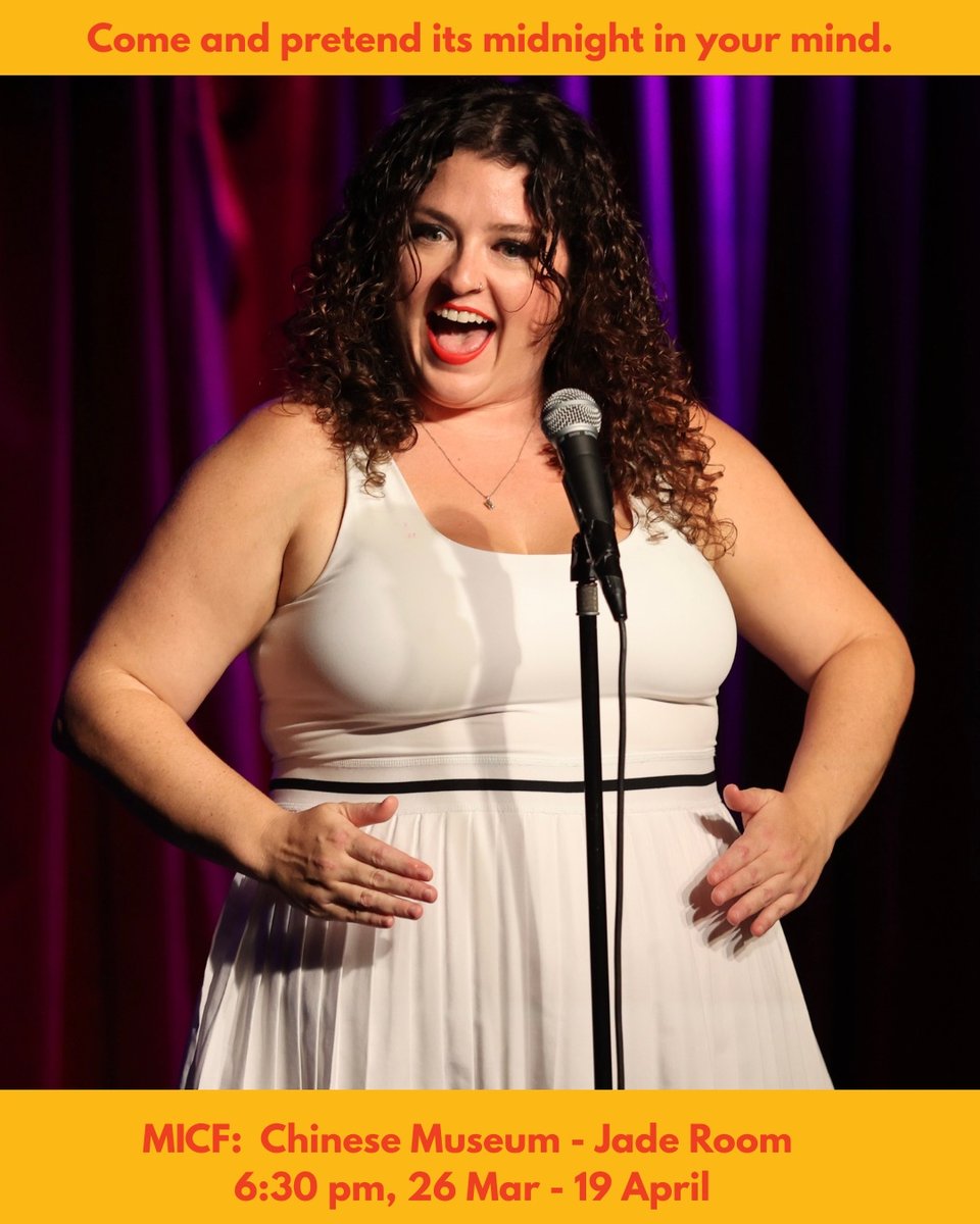 The same woman stands in front of a mic onstage