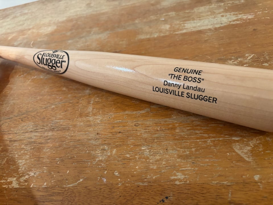 A Louisville slugger bat with the inscription: “Genuine Louisville Slugger - ‘The Boss’ - Danny Landau”