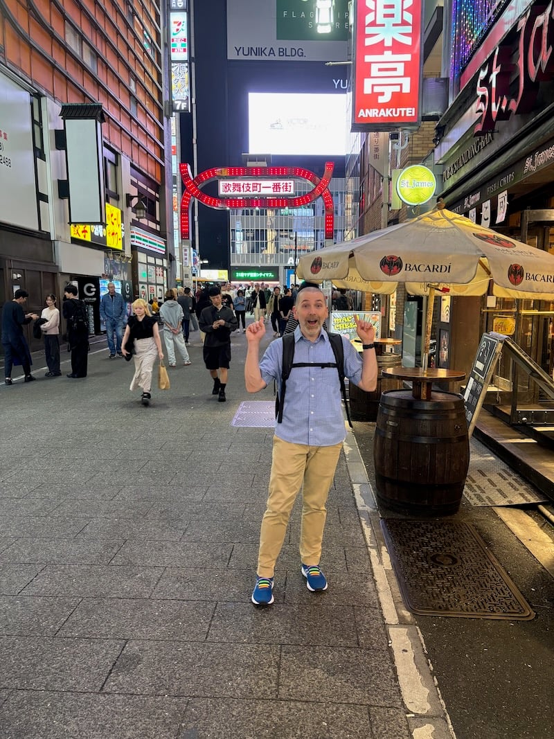 a man standing on a street in tokyo