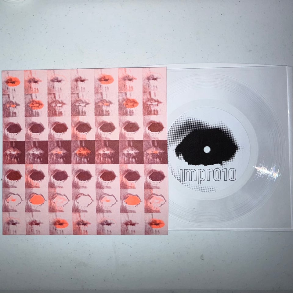 an image of a square 7" clear lathe cut record and a pink, orange, and burgundy sleeve on a white table