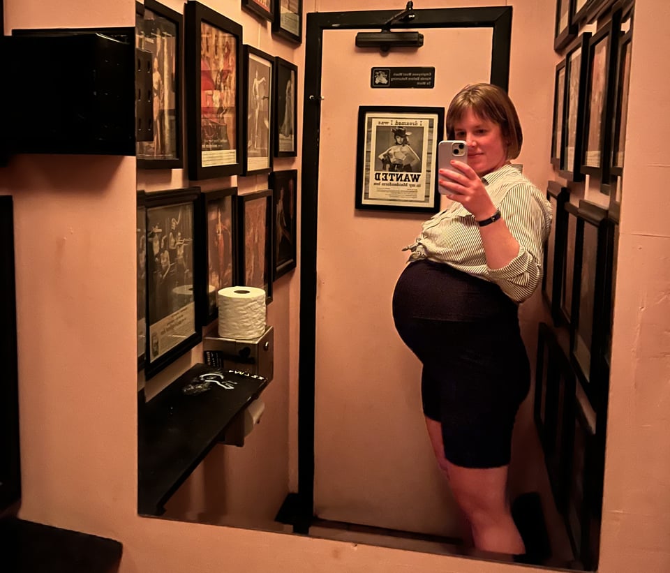 A mirror selfie of me, super pregnant, in the bathroom at Delux, the best place on the planet