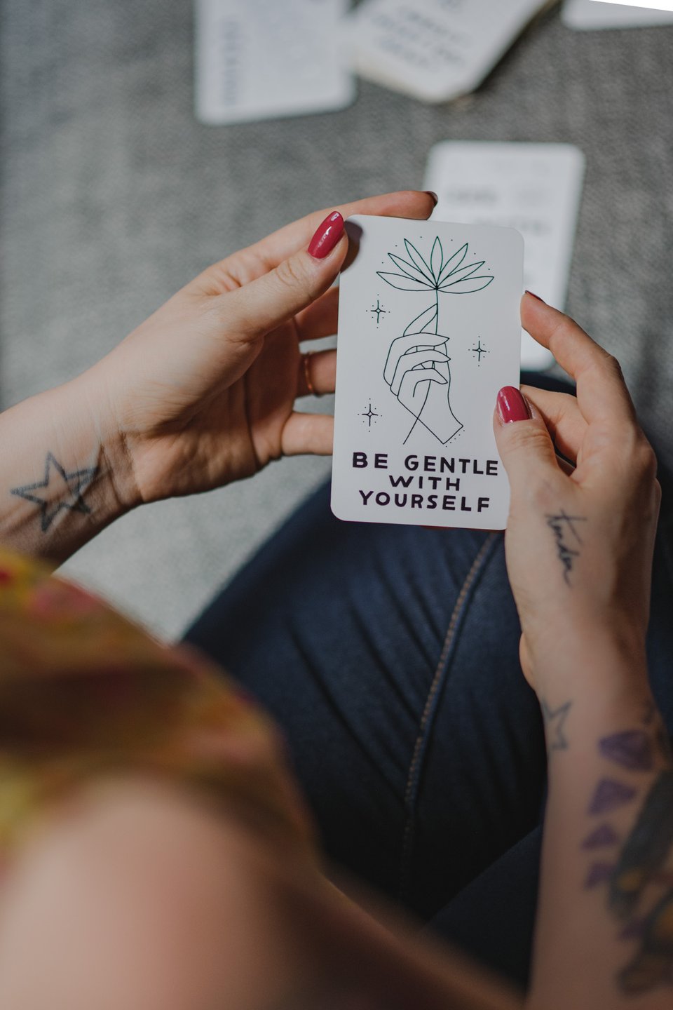 kate holding a card that says "be gentle with yourself"