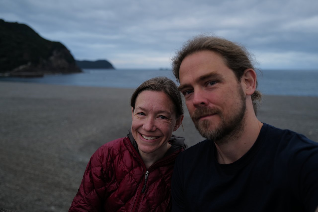 a man and woman in a selfie on a beach