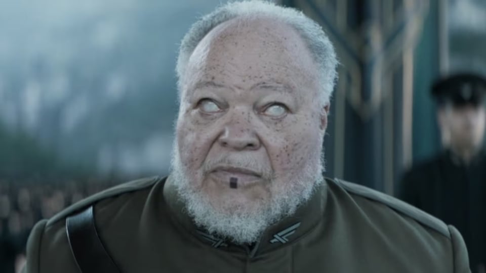 A man with freckled light coffee skin and wiry gray hair (present towards the back of his head) and beard, small ears, and a black rectangular tattoo upon his lower lip (think of a tombstone on a mathematical proof), wearing an olive military uniform with a black Sam Browne belt coming out of his right shoulder, looks forward with eyes that have gone literally blank; you see a small amount of the color of his iris, but it's otherwise as if he's gone blind.

That's Stephen McKinley Henderson, playing Thufir Hawat (more on him later), calculating the amount of solaris the Imperial House must've spent to personally send a Herald of the Change to Caladan to announce House Atreides has been given the fief of Arrakis.