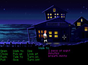 This image is a screenshot of the gameplay in the video game The Secret of Monkey Island. It displays the game's protagonist, Guybrush Threepwood, standing in front of a pirate tavern by the docks. The point-and-click interface below the scene displays a list of the verb commands in green text and items in the player's inventory in purple text. 