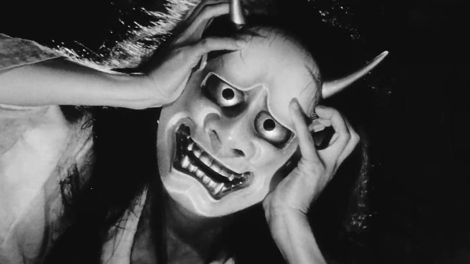 A fram from Onibaba. The old woman is wearing the samurai mask.