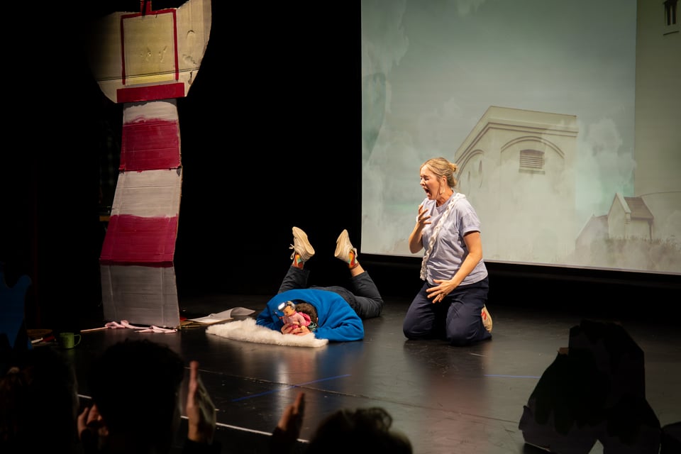 Oli birthing a baby doll from his head while Lesa kneels besides, screaming