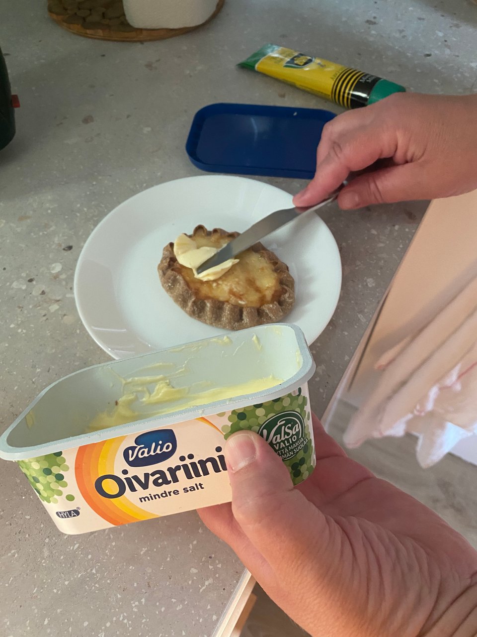 a person buttering a Karelian Pastry for breakfast