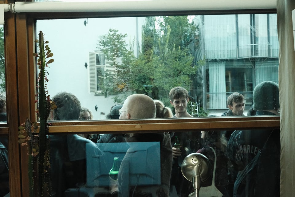 People hanging out, seen through a window