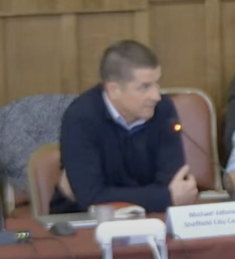 Michael Johnson speaking into a microphone