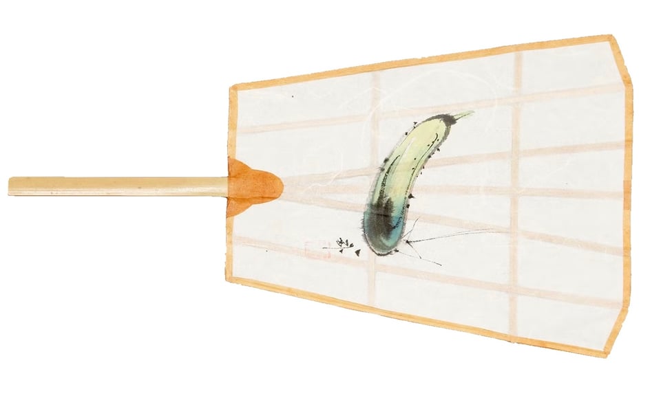 A Japanese paper fan with a bamboo handle and a painting of a cucumber to assist cooling.