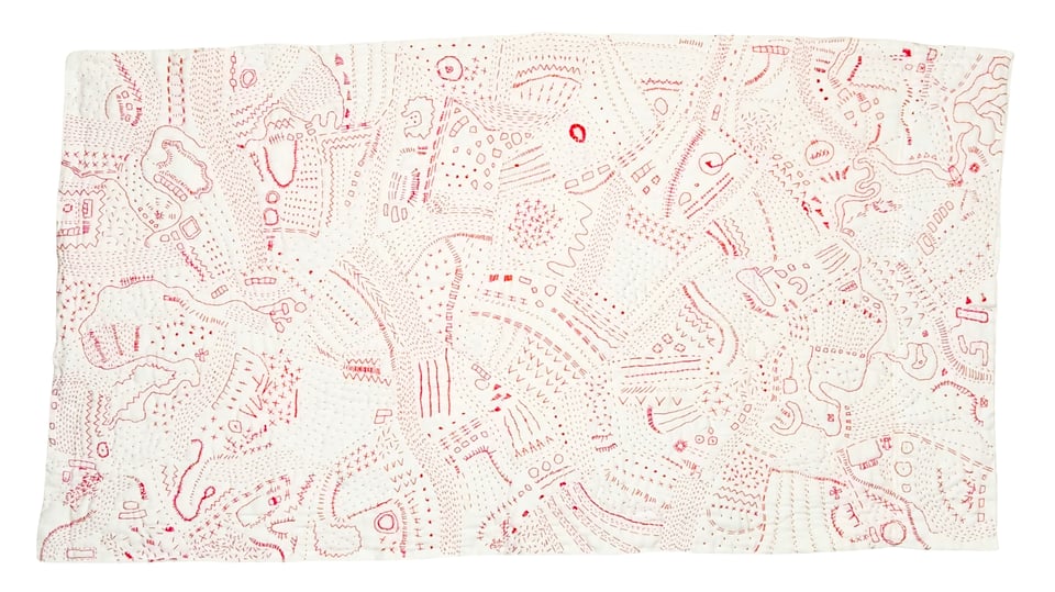 Red Map, a hand stitched quilt by Sarah Atlee. The quilt is red thread on a white pillowcase, 21 inches tall by 38 inches wide. A variety of shapes and symbols in red thread form an imaginary map.