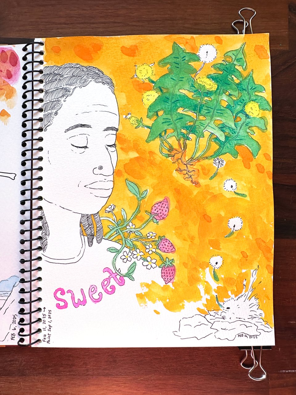 A black and white drawing of a person closing their eyes with a slight smile, some dandelions, and some strawberries in a sketchbook that has been painted in shades of orange, pink, and green at a later date. The paint lends a warm energy to the sketch, inviting the eye to linger on the texture of the background and enjoy the plants.