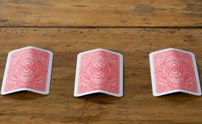 a card game, three cards in a row, pick the Queen, known as three card monte or find the lady