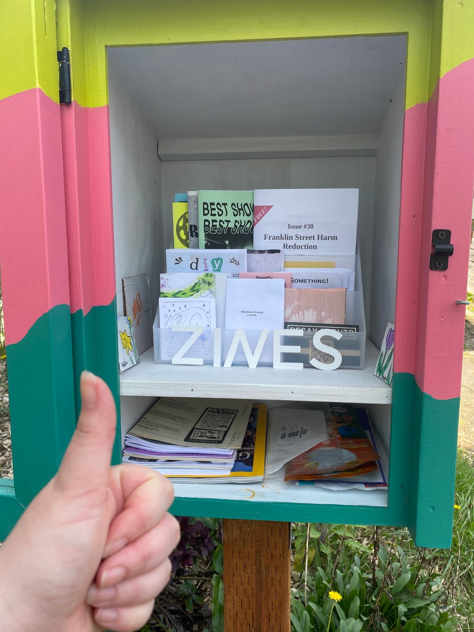 somebody yoinked the letter N from my little free zine library sign, i cut up a W to make a funny italicized N replacement.