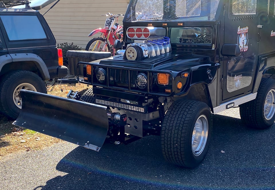 Snow plow on the front of the golf cart
