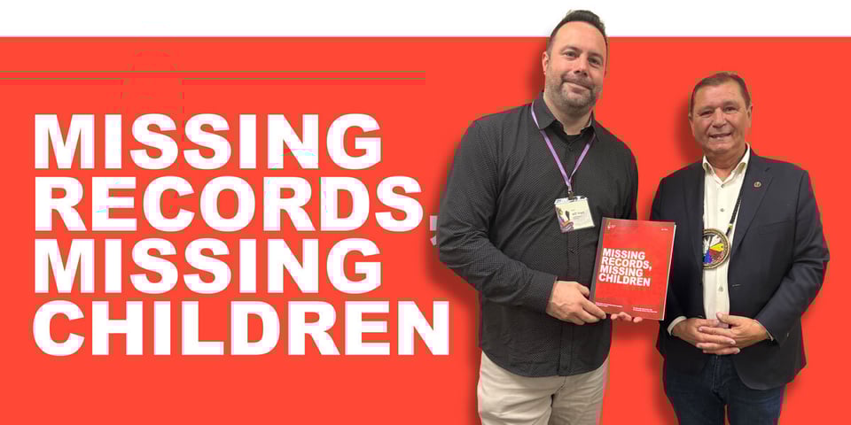 A photo of two Indigenous men in suits, one with a conference lanyard, the other with a beaded medallion around his neck. They are standing side by side and presenting a report to the viewer. The background is red and on the left are the words MISSING RECORDS, MISSING CHILDREN.