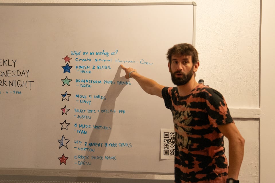 Drew pointing to an item on the whiteboard that he completed.