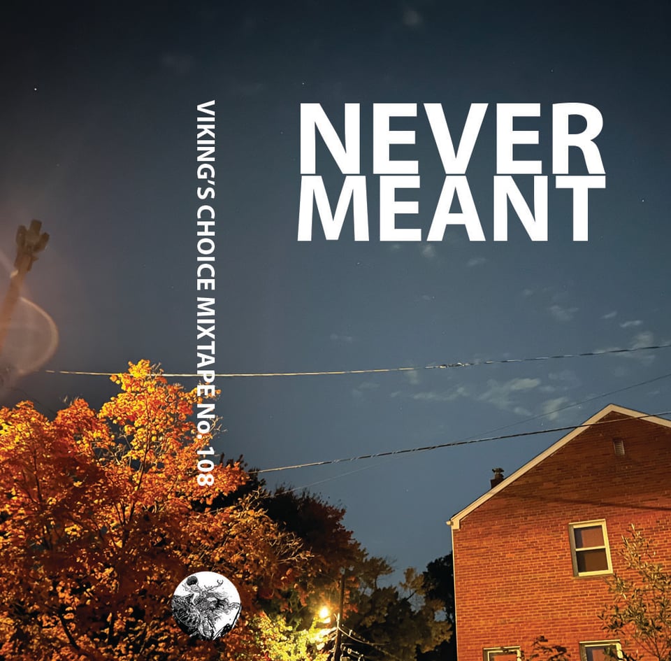 An autumnal dusk with changing leaves and a brick house.