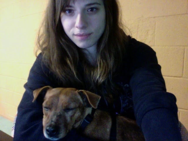 Heidi sleeps in Meredith's arms in 2010. Meredith is in her 20s and Heidi is barely a full-grown dog.