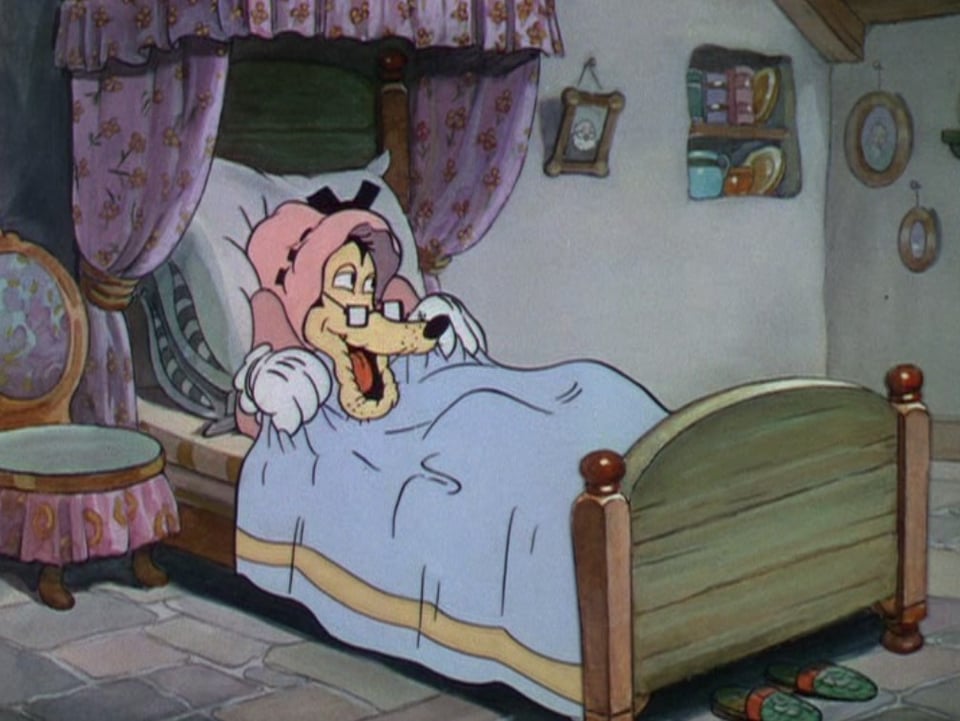 A cartoon depiction of the Big, Bad Wolf, dressed up like grandma, with the bedsheets drawn up around his neck.