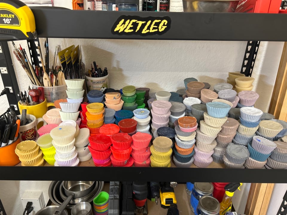 A shelf in my art studio filled with wax cups in different colors. Forbidden Reese's cups!