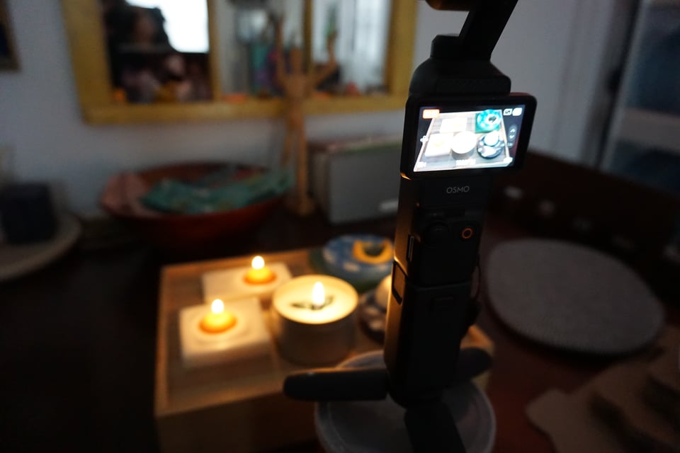 photo of my table and i'm doing a burn test of a bunch of my candles, but the focus is on the camera i'm using to document the process