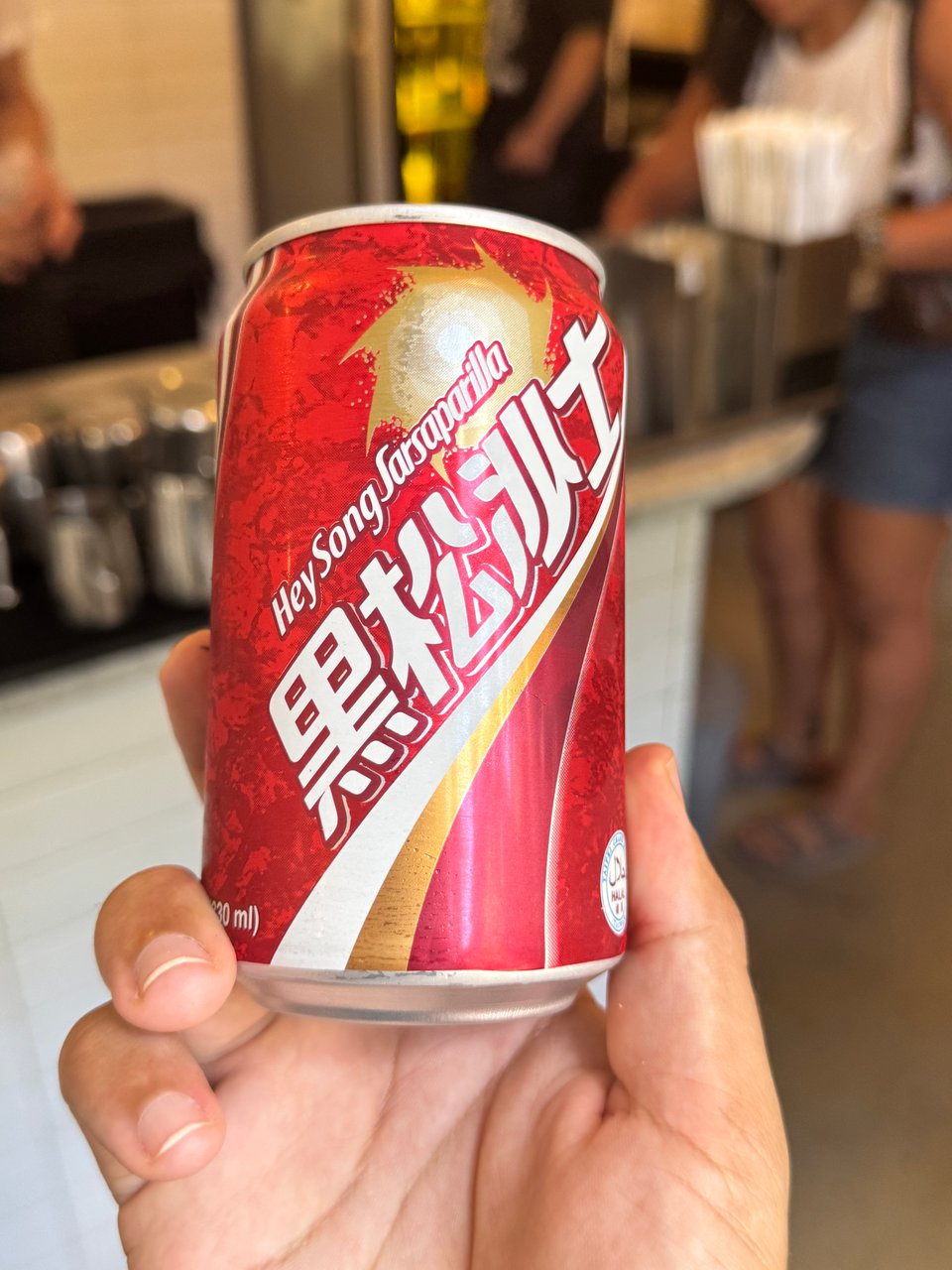 my hand holding a can of HeySong Sarsaparilla