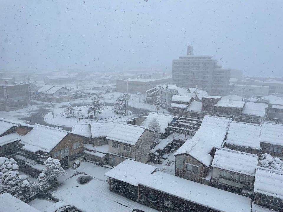 An overhead view of the Toyooka residential area covered in snow.